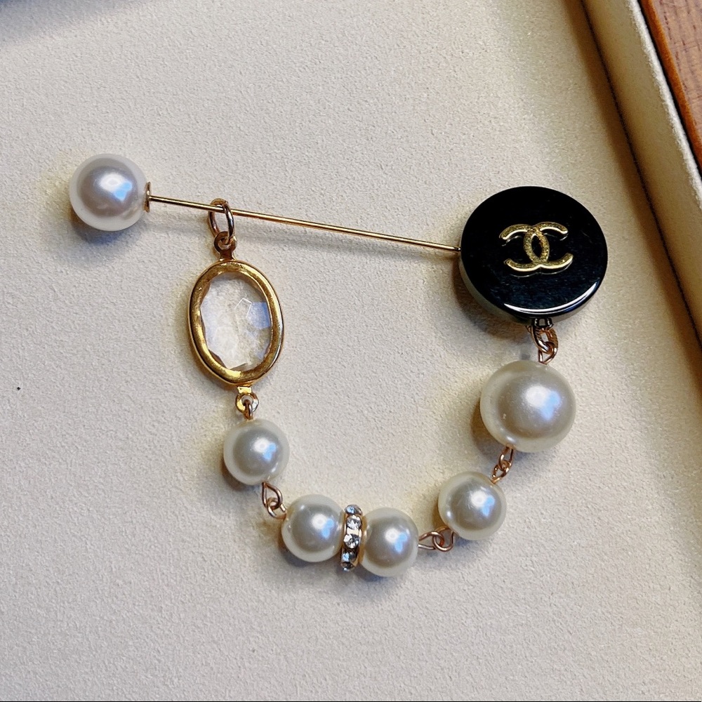 Chanel black and gold logo pearl brooch